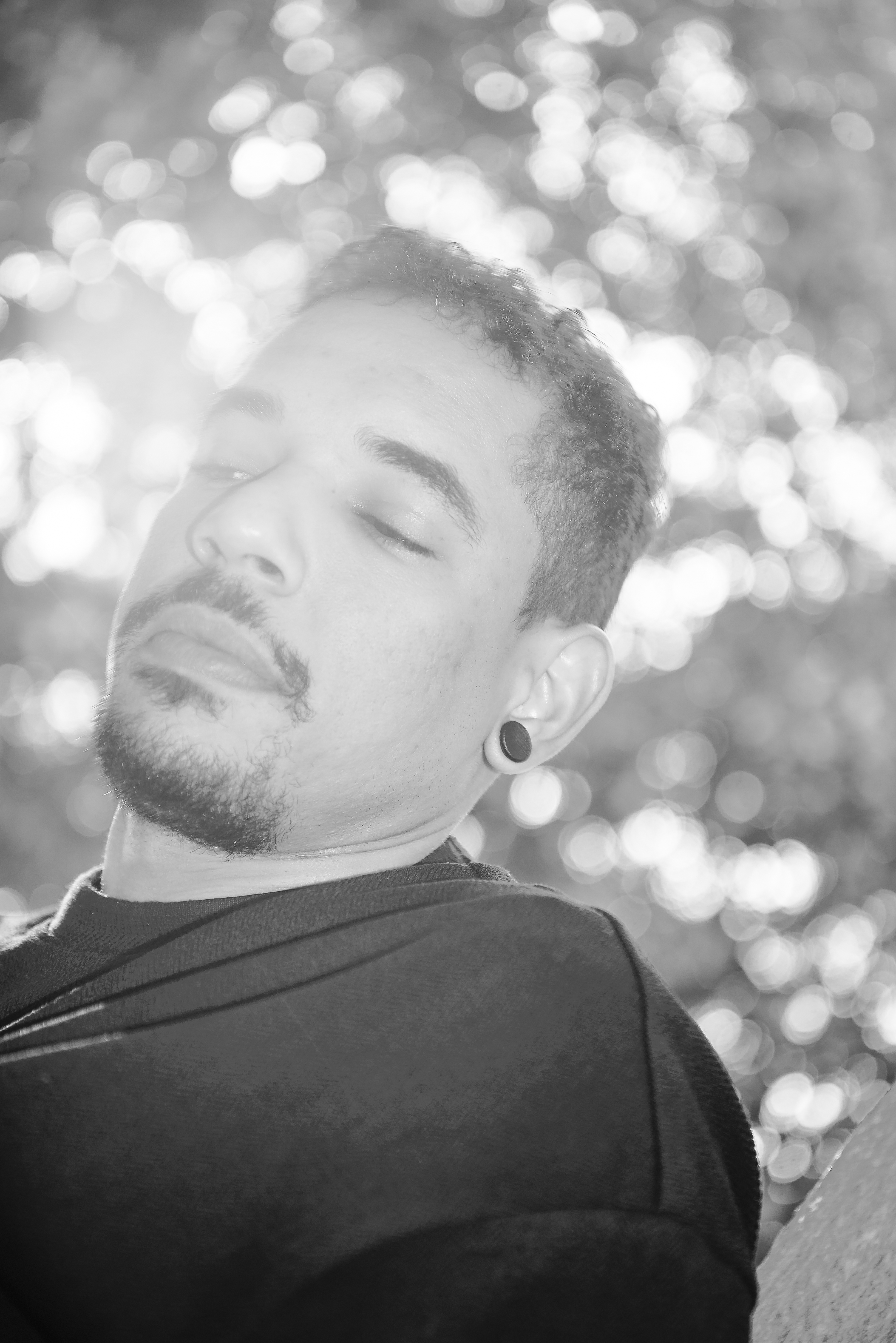 Close black-and-white portrait of Maxim against soft lights